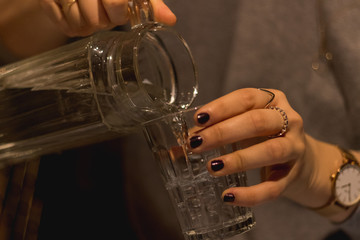 Person pouring water into glass