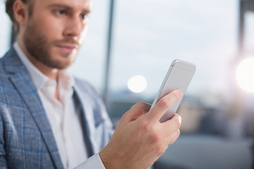 Close up of office worker using telephone to communicate. Focus on device