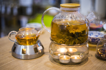 Blooming Flower Tea in Glass Tea Pot with traditional chinese accessories stay on the table in teashop