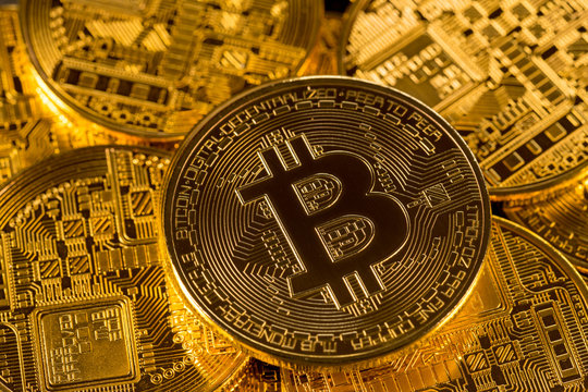 Stack of bitcoins with gold background