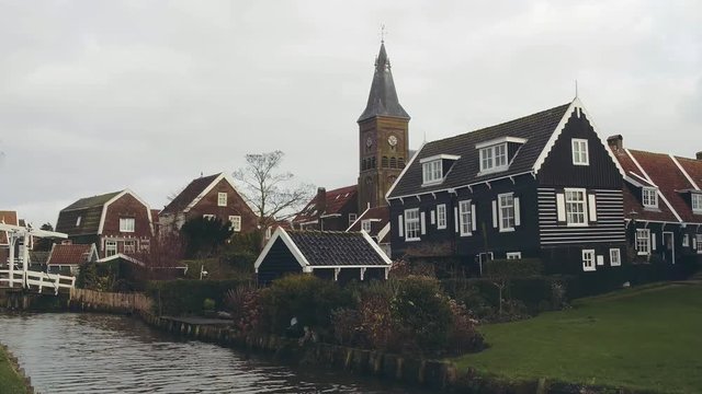 Small houses and clocktower in traditional Dutch village Marken, Netherlands