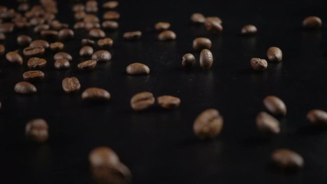 Jumping coffe beans on black background