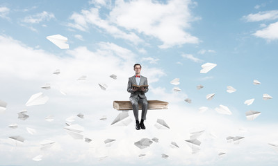 Young businessman or student in blue sky studying the science