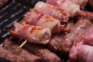 Chicken meat wrapped in bacon and cevapcici