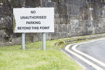 No unauthorised parking beyond this point sign at road