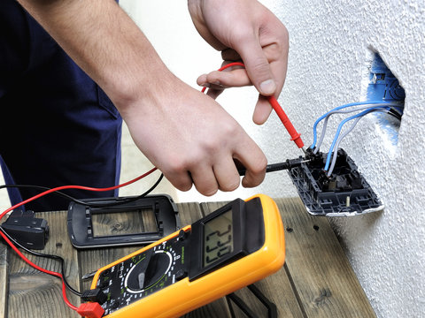 Young electrician working in a residential electrical installation
