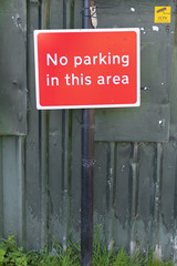 No parking in this area sign on metal shed