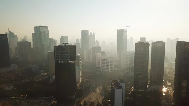 JAKARTA - Indonesia. December 26, 2017: Aerial Jakarta city landscape in the morning with smoke or mist near the skyscrapers, shot in 4k resolution