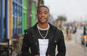 Colorful street scene portrait of a young African American male model