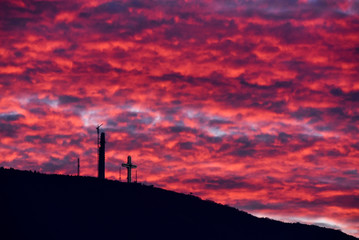 Colorful dramatic sunset with red sky and a mountain