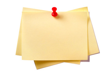 Yellow sticky post it note oblong pile stack with pin pushpin isolated on white background photo