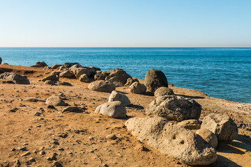 Boulders and rocks near a cliff edge at the Point Loma tidepools in San Diego, California.