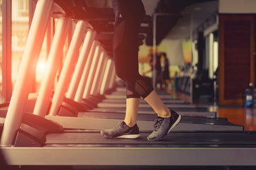 Fototapeta na wymiar Exercise treadmill cardio running workout at fitness gym of woman taking weight loss with machine aerobic for slim and firm healthy lifestyle in the morning.