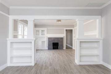 Living Room interior after remodelling with fire place and grey wooden floor for virtual staging.