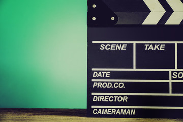 movie clapper on wood table ; film, cinema and vedio photography concept