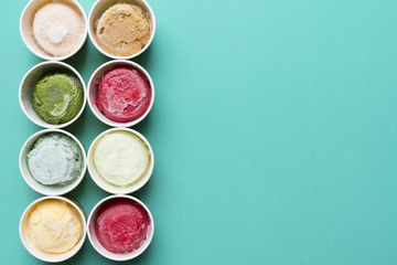 Top view of Ice cream flavors in cup and topping, sweet and dessert food concept