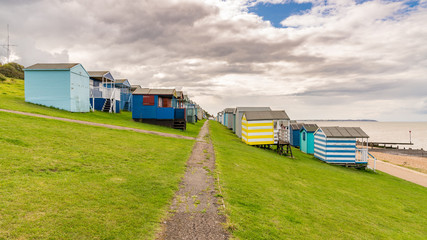 Rows of beach huts on the North See coast at the Tankerton Slopes in Whitstable, Kent, England, UK