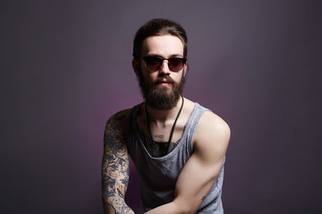 handsome man with tattoo and sunglasses