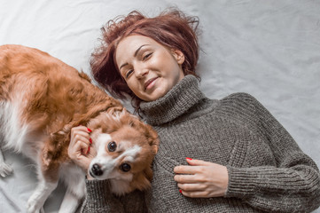 young woman lies with a dog