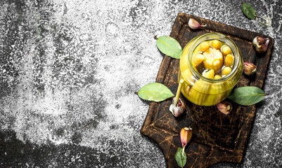 Marinated corn in glass jar.