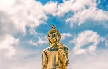 Fototapeta na wymiar gold Buddha statue and blue sky