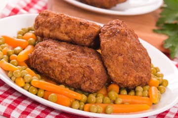 Meatballs on white dish.