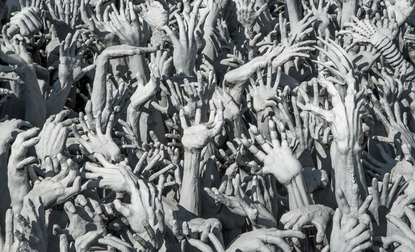 Reaching hands as a Buddhist depiction of Hell at the White Temple in Chiang Rai Thailand