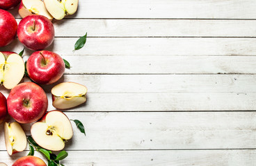 Fresh red apples with leaves.