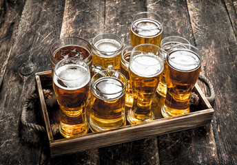 Glasses with fresh beer on an old tray.