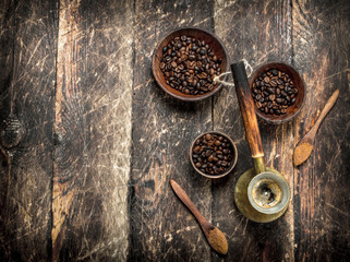 Coffee background. Freshly brewed coffee with grains in a bowl.