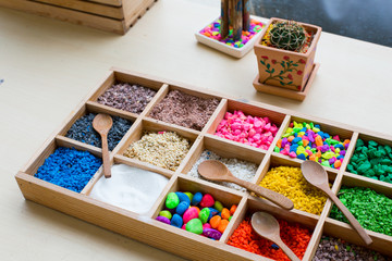 Colored pebbles mini stone and wooden spoons in wooden boxes for mini terrarium
