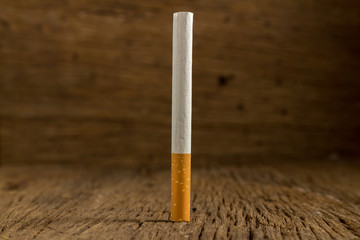 Tobacco cigarette on a  wooden