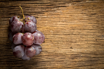 red grapes on wooden table