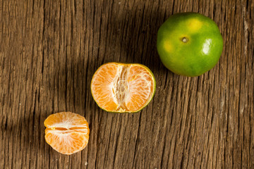 tangerine. sweet orange. on wooden. texture wooden