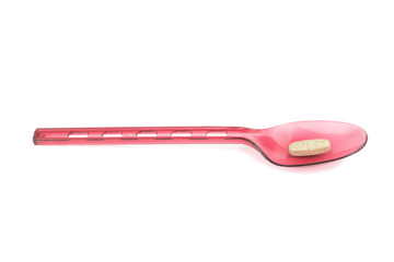 red spoon plastic with supplementary garlic  isolated on white background