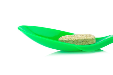 green spoon plastic with supplementary garlic  isolated on white background