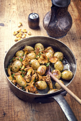 Fresh fried chanterelle with potatoes as top view in a casserole