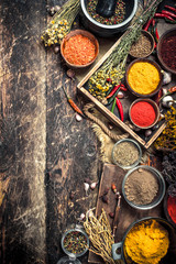 Various ground spices and herbs in an old tray.