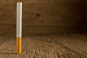 Tobacco cigarette on a  wooden