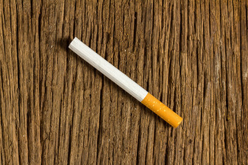 Tobacco cigarette on a  wooden