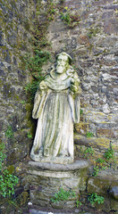 ontedeume, Galicia / Spain. July 29, 2017. Ancient medieval stone statue depicting Saint James in front of a stone wall