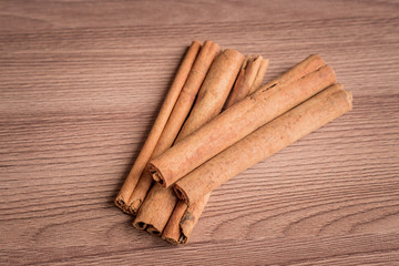 cinnamon sticks on wooden table.