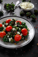Homemade Roasted Green Kalettes salad with cherry tomatoes and feta cheese. healthy food