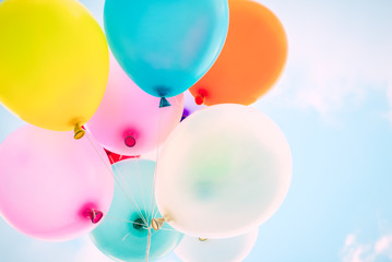 Multicolor balloons on blue sky. Ideas for the background of love in summer and valentine, wedding...
