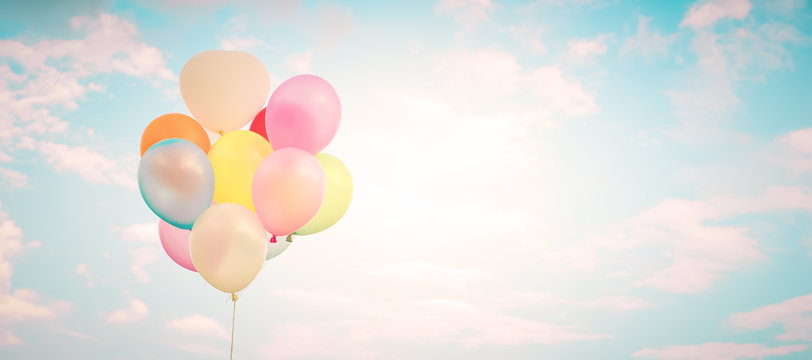 Vintage multicolor balloons with done with a retro instagram filter effect on blue sky. Ideas for web banner background. Love in summer and valentine, wedding honeymoon concept.