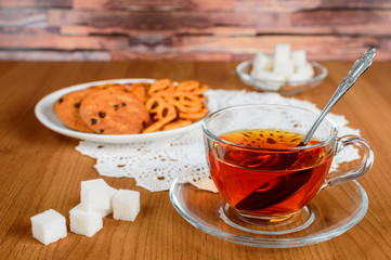 rich tea in a glass Cup. cookies and refined sugar
