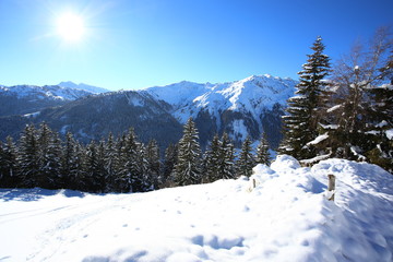 Wintery mountain landscape with sunshine