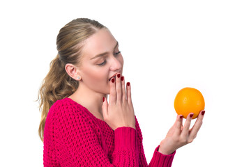 Beautiful portrait of young woman with orange. Healthy food concep