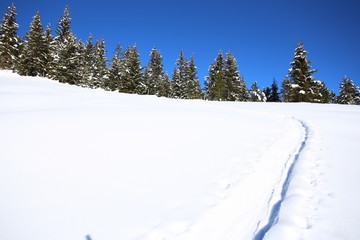 Wintery mountain landscape with sunshine