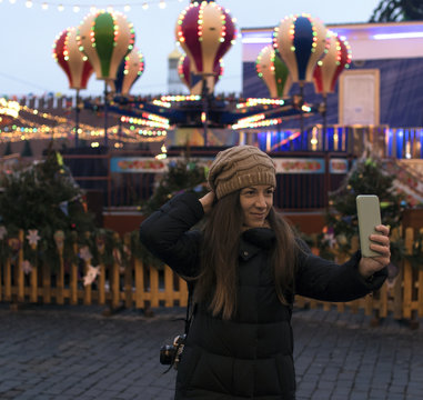 young woman at the Christmas market doing selfie on the phone